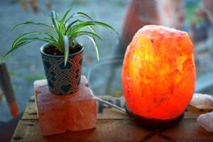 Himalayan salt lamps are crafted from amber-hued rock salt crystals, shaped with a hollow center to accommodate a lightbulb. When illuminated, these lamps emit a cozy reddish-pink glow.